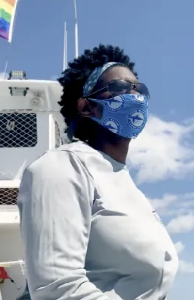 Woman stands on boat