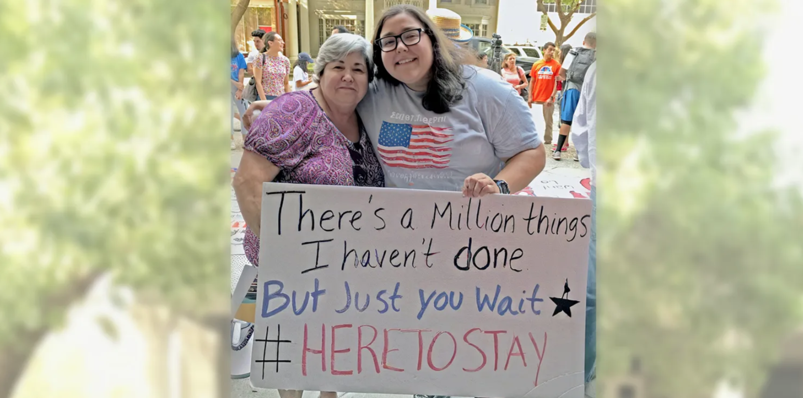 two people holiding a sign